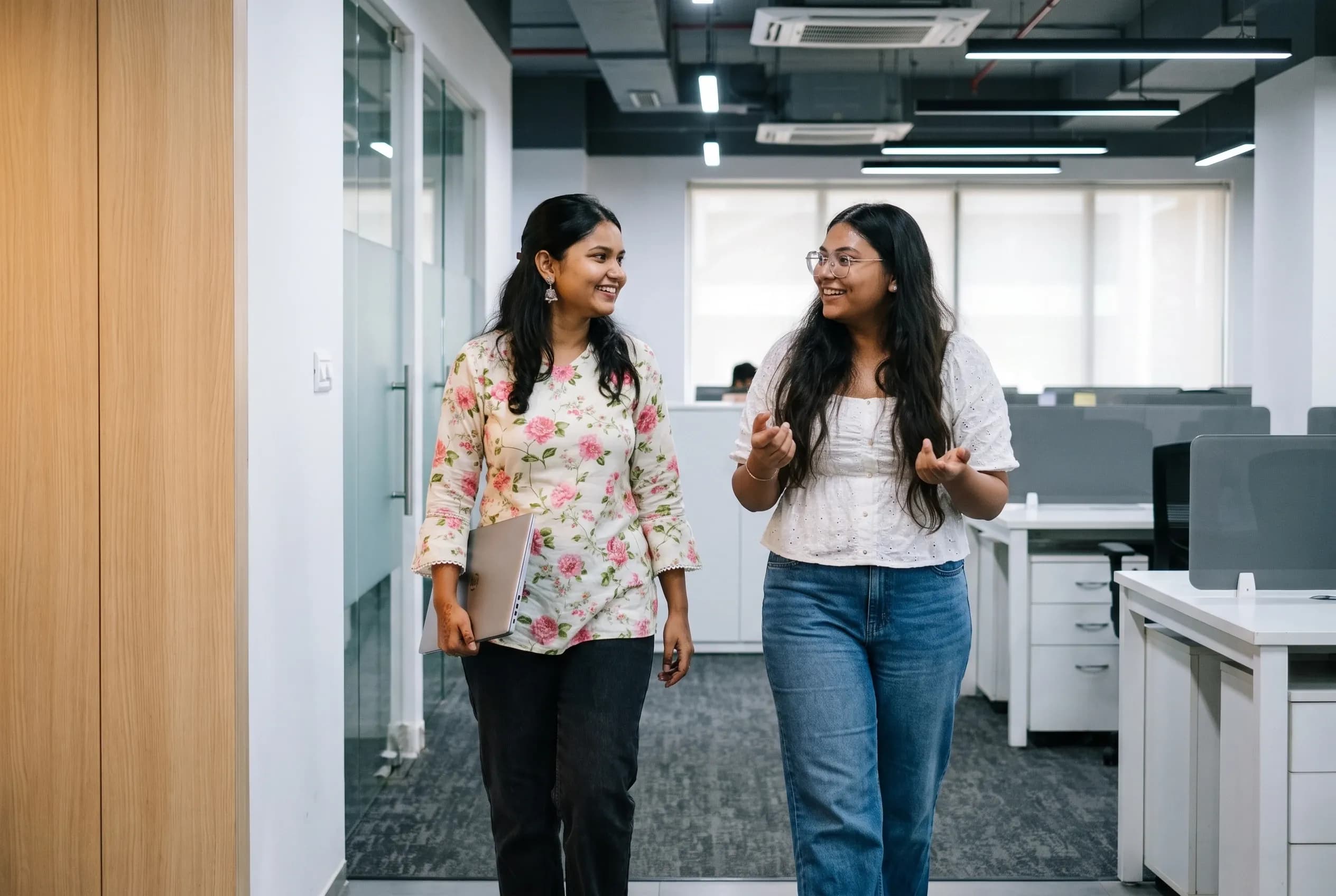 Two DigiIQ team members talking on their way through the office