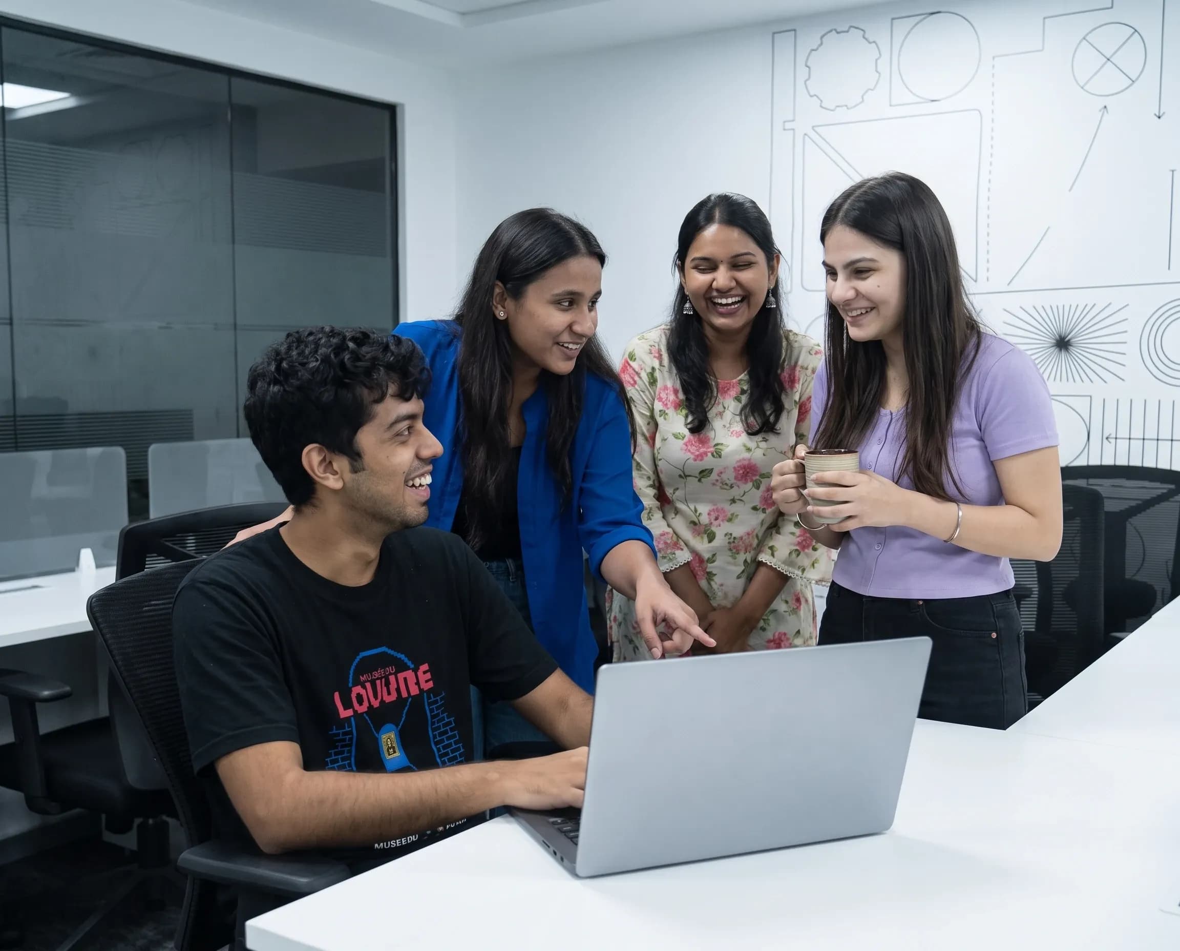 The DigiIQ team reviewing new work together at a laptop